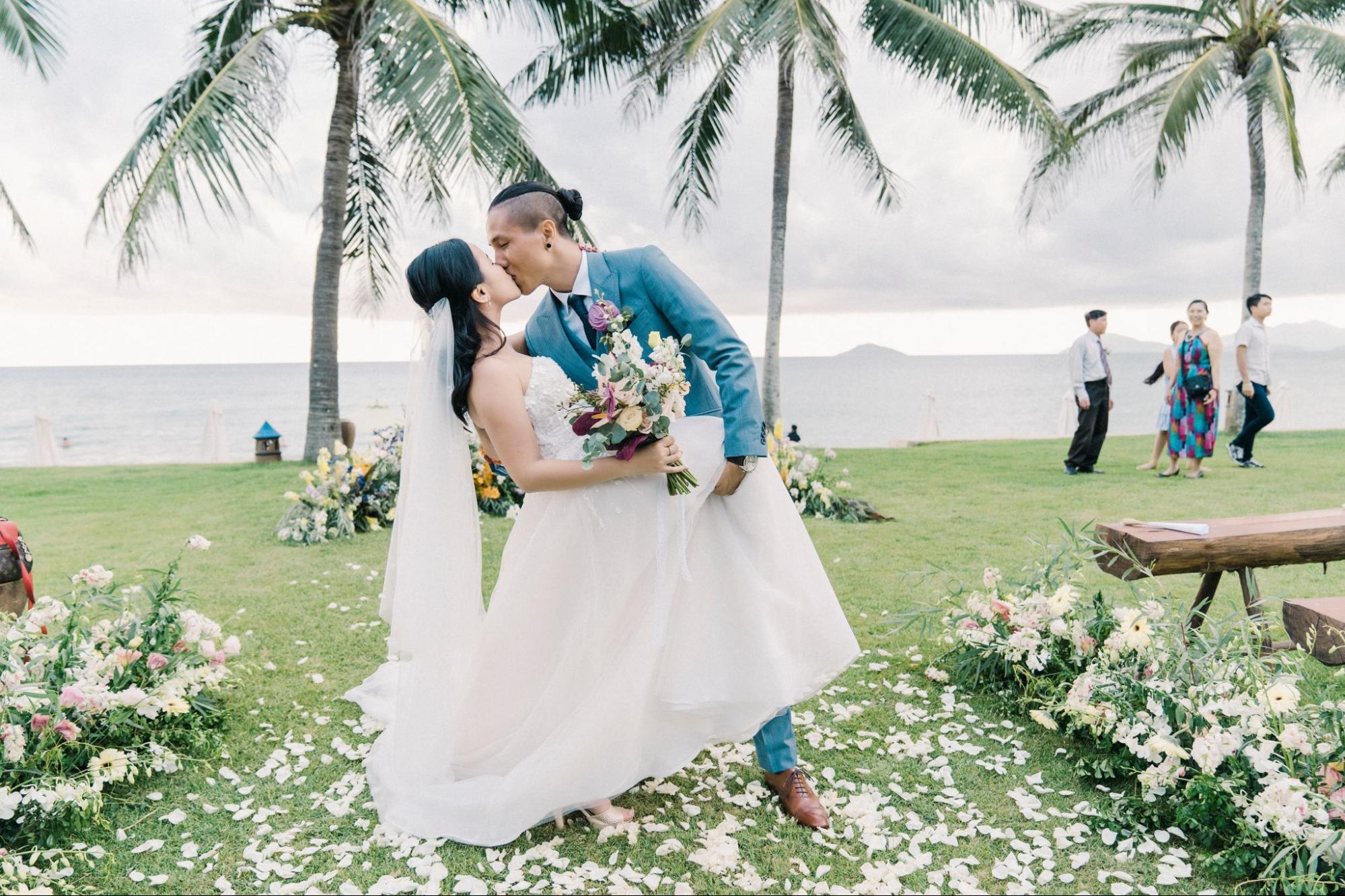 A bride and groom share their first kiss as a married couple and have a  moment together during their marriage vows ceremony at a Stock Photo - Alamy